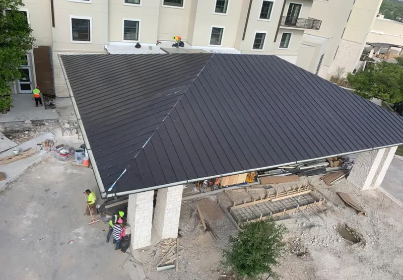 Metal roofing installation team working on a commercial building in Roanoke